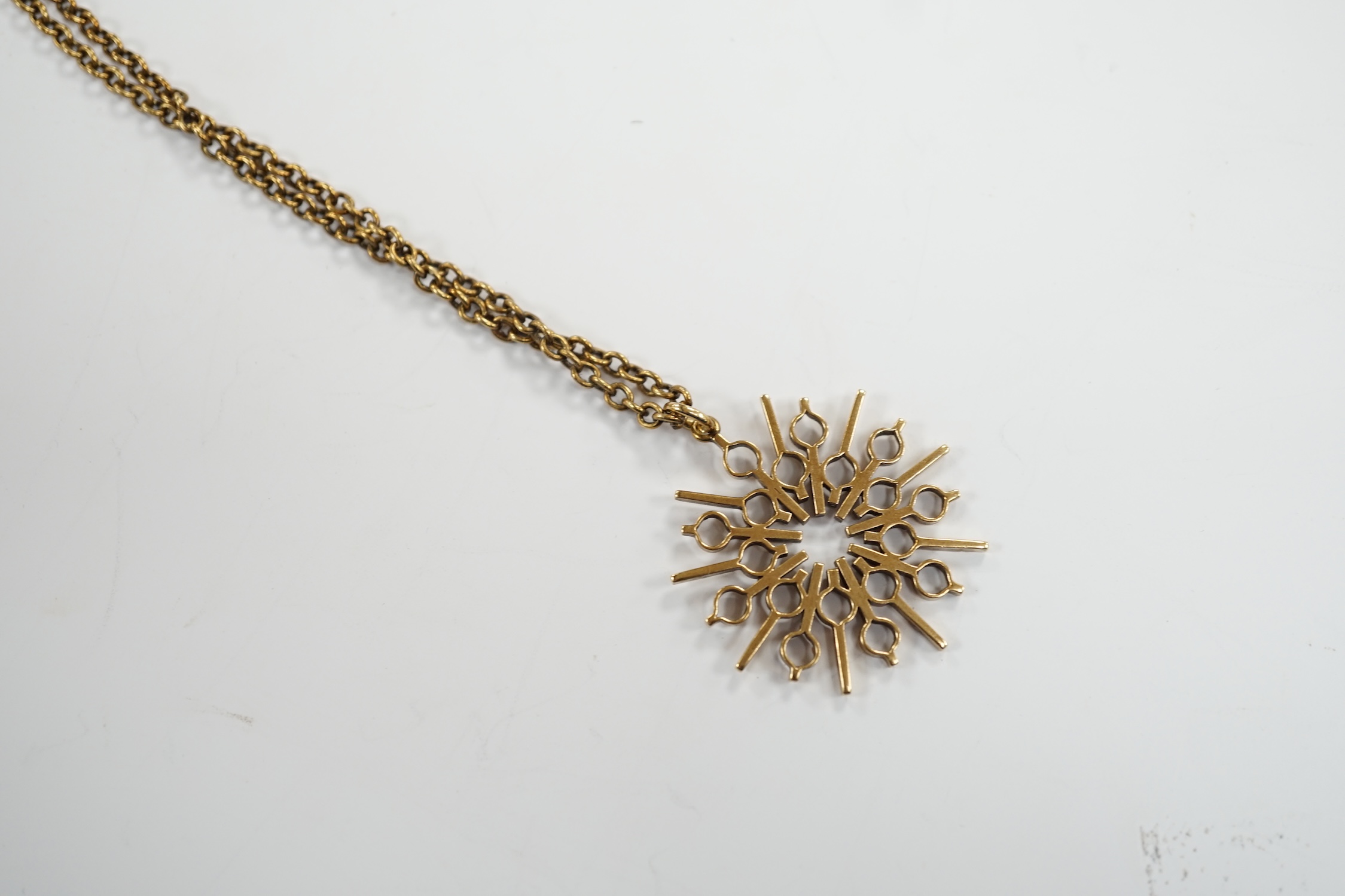 A yellow metal pendant, 37mm, on a 375 chain, 52cm, gross weight 17.8 grams.